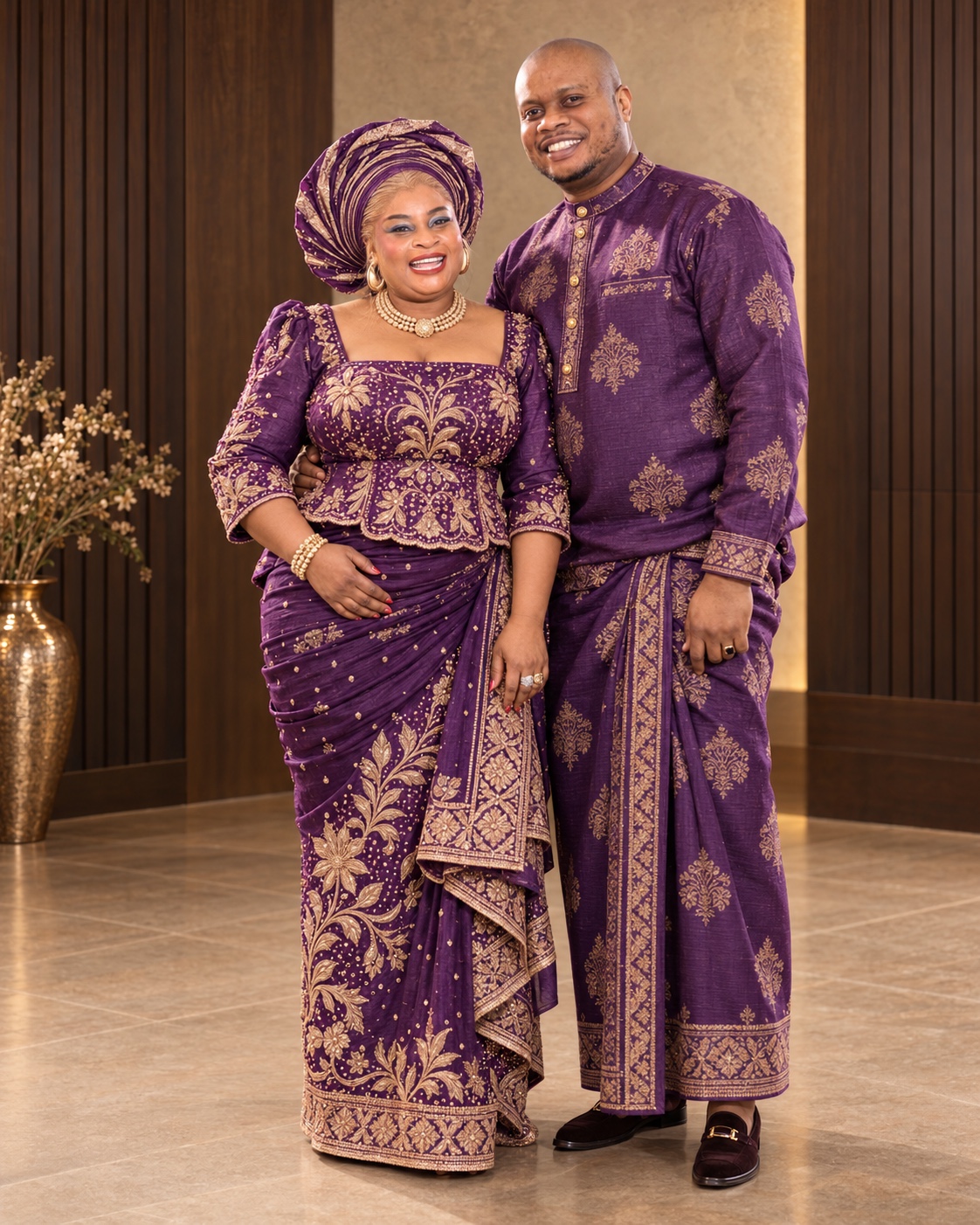 Uchamma and Igwe standing together in full-length purple and gold heritage attire